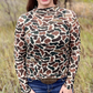 Woman in camo shirt and jeans.