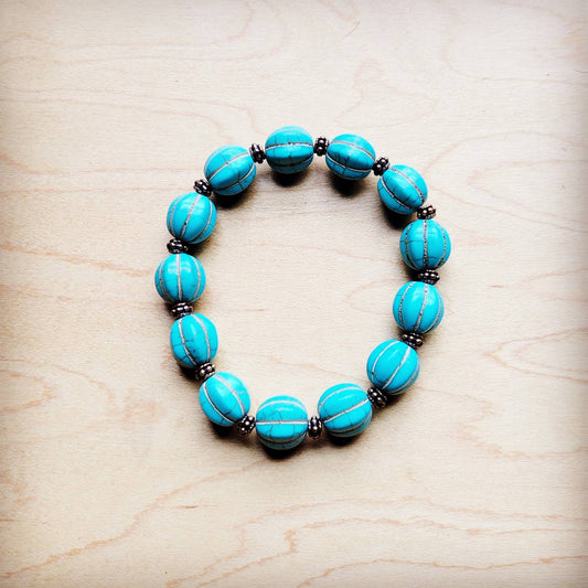 Turquoise beaded bracelet on a wood surface.