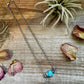 Turquoise beaded necklace on wood, image 66AA34D3