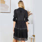 Woman in black dress from behind.