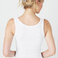 Woman in white tank top from the back.