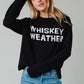Woman in black sweater with Whiskey Weather text.