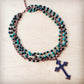 Necklace with turquoise beads and a cross pendant.
