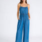 Woman in a blue denim jumpsuit.