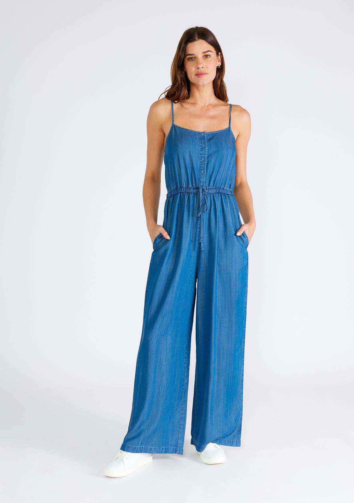 Woman in a blue denim jumpsuit.