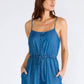 Woman in a blue denim jumpsuit.