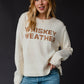 Woman in Whiskey Weather sweater.
