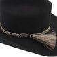 Black cowboy hat with decorative band and tassel.
