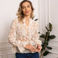 Woman in lace blouse and jeans.