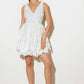 Woman in white lace dress and heels.