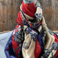 Silk scarf with paisley print and red and blue accents.