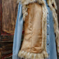 Faux fur vest over denim shirt
