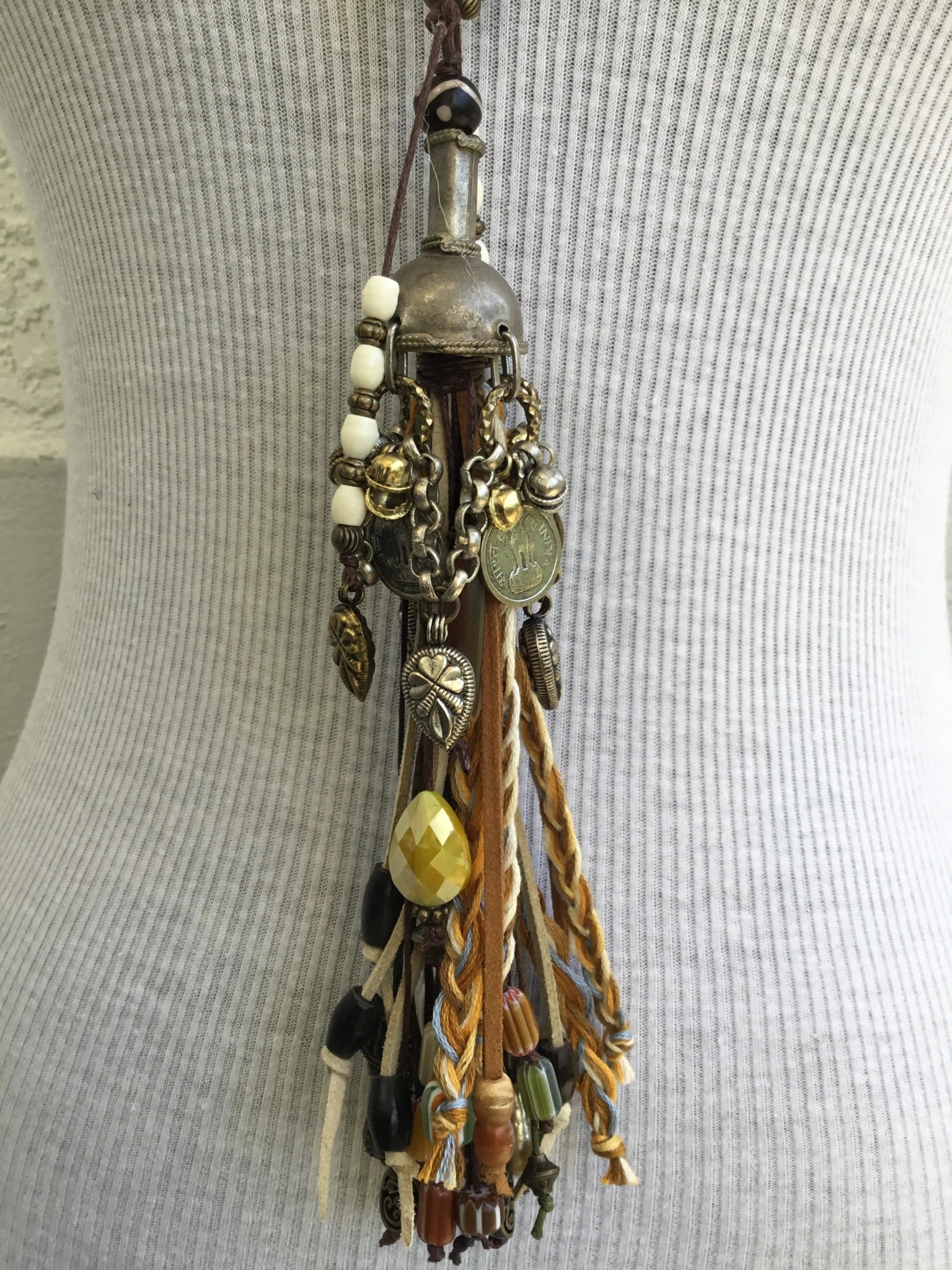 Beaded tassel pendant necklace on gray top