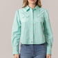 Annie in turquoise button-up crop top