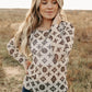 Woman wearing brown and cream patterned top