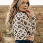 Woman in brown and cream patterned top