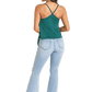 Woman in green tank top and jeans with hat