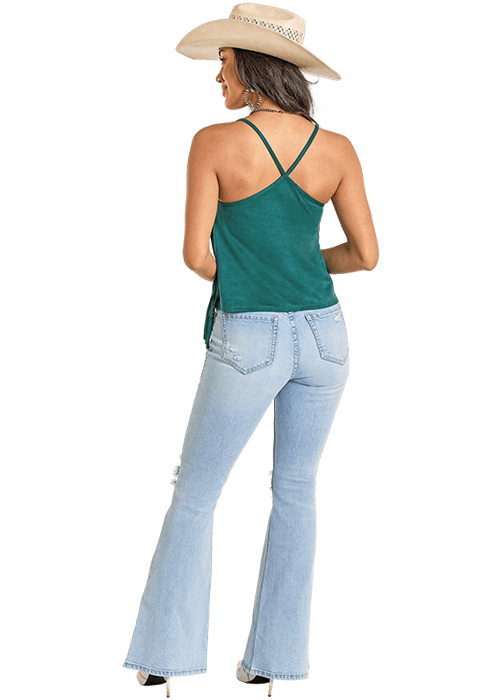 Woman in green tank top and jeans with hat