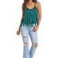 Woman in green fringe top and ripped jeans
