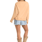 Woman in BW91T08105 sweatshirt, denim shorts, and cowboy boots