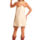 Cowgirl in beige dress and cowboy boots