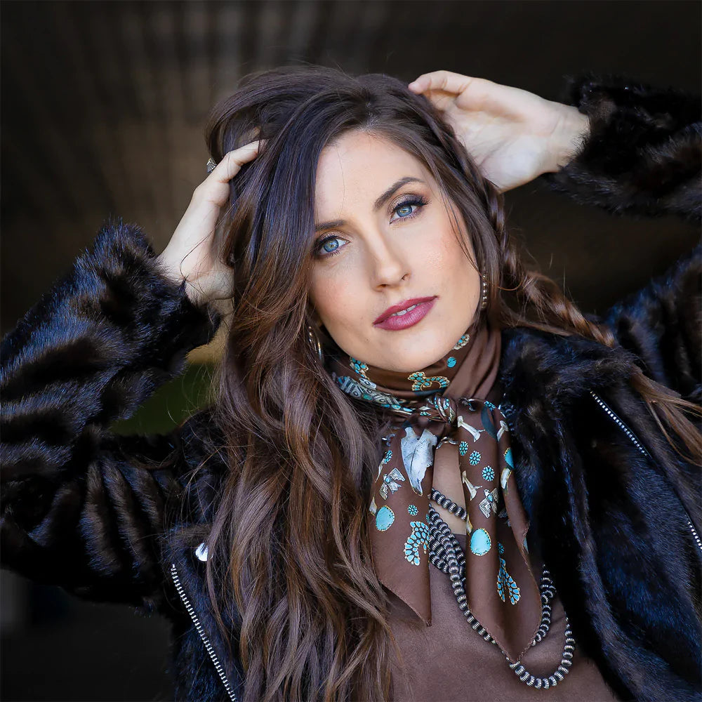 Woman wearing brown fringe scarf and black jacket