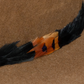 Brown hat with feather detail