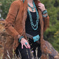 Woman in suede jacket and turquoise jewelry