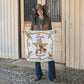 Cowgirl holding Always Saddle Your Own Horse bandana