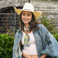 Cowgirl in denim jacket and cowboy hat