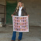 Woman holding horse head print scarf