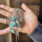 Turquoise beaded necklace held in hand - EC472120
