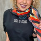 Woman in God is Good sweatshirt with colorful scarf