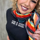 Woman smiling, God is Good shirt, colorful scarf