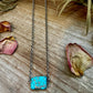 Turquoise stone necklace on wooden surface