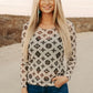 Woman wearing patterned top and jeans