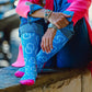 Woman in pink blazer and blue jeans with patterned socks