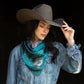 Woman wearing silk wild rag scarf and cowboy hat.