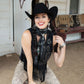 Cowgirl wearing black wild rag scarf and concho, smiling.
