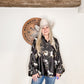 Woman in cowboy hat and printed blouse.