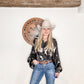 Woman in cowboy hat and shirt, jeans.