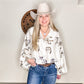 Woman in cowboy hat and patterned blouse.