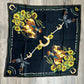 Black bandana with cowboy and floral design.