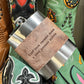 Flask with leather band and cowboy boots.