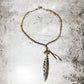 Beaded necklace with pendant and tassel.