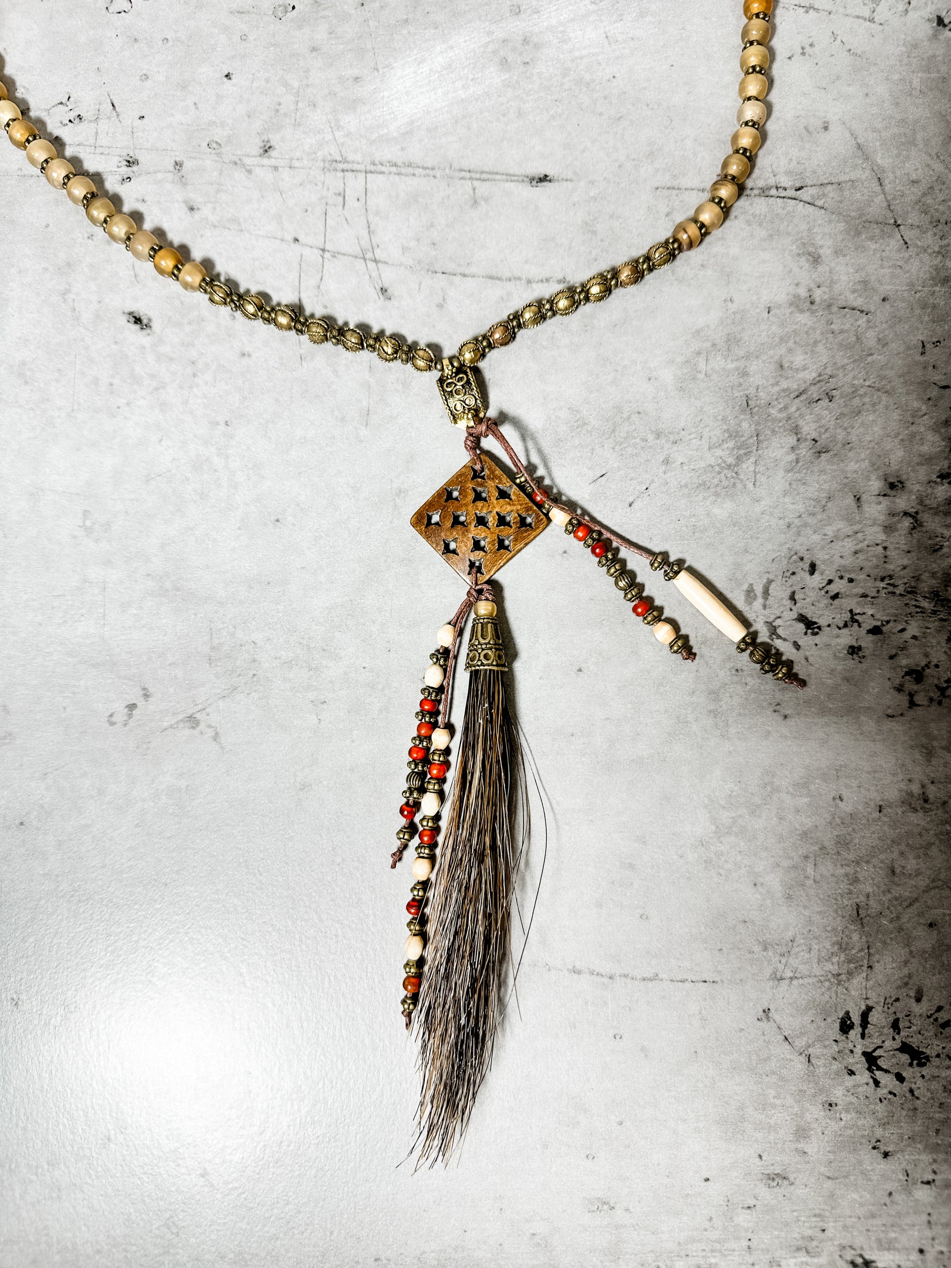 Necklace with beaded chain and pendant.