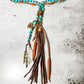 Turquoise beaded necklace with leather tassel pendant.