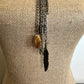 Necklace with feather and stone pendants.