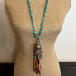 Turquoise beaded necklace with tassel detail on mannequin