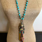 Turquoise beaded necklace with tassel on display (IMG_28482)